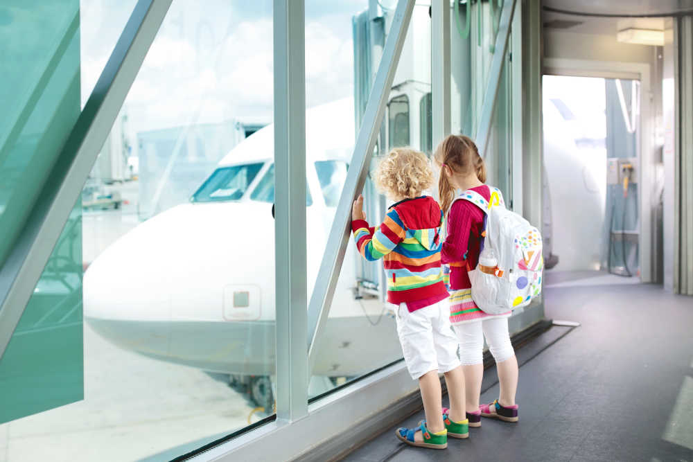 generic-children-looking-at-airplane-jet-bridge-medium